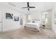 Bright and spacious main bedroom with plush carpet, tray ceiling, and natural light from multiple windows at 120 Keats Aly, Cramerton, NC 28032