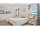 Bedroom with light colored walls, carpet, and a bed situated between two windows with patterned curtains at 12109 Lady Bell Dr, Charlotte, NC 28278