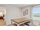 Well-lit dining area featuring a table with stools, natural light, and an adjacent bedroom at 12109 Lady Bell Dr, Charlotte, NC 28278