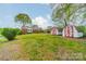 Backyard view of a well-maintained lawn with two sheds at 1400 Russell Ave, Charlotte, NC 28216