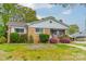 Quaint brick home featuring lovely landscaping and a well-manicured lawn at 1400 Russell Ave, Charlotte, NC 28216