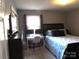 Bedroom with computer set up, a large window and a bed with a patterned comforter at 1414 Farmstead Rd, Rock Hill, SC 29732
