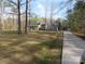 Expansive front yard and long driveway leading to a charming gray home, perfect for Gathering living at 1414 Farmstead Rd, Rock Hill, SC 29732