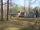 Expansive front yard and long driveway leading to a charming gray home and outbuilding at 1414 Farmstead Rd, Rock Hill, SC 29732