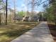 Expansive front yard and long driveway leading to a charming gray home and outbuilding at 1414 Farmstead Rd, Rock Hill, SC 29732