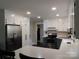 This lovely kitchen features white upper cabinets with stainless steel appliances at 1414 Farmstead Rd, Rock Hill, SC 29732