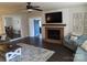 Comfortable living room features hardwood floors, a ceiling fan, fireplace and access to other rooms at 1414 Farmstead Rd, Rock Hill, SC 29732