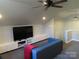 Spacious living room featuring a ceiling fan, tv, and comfortable blue couch at 1414 Farmstead Rd, Rock Hill, SC 29732
