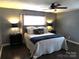 Relaxing main bedroom features soft lighting, a plush bed, and dark wood floors at 1414 Farmstead Rd, Rock Hill, SC 29732