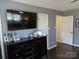 This main bedroom features dark wood floors, a dresser, and a wall-mounted tv at 1414 Farmstead Rd, Rock Hill, SC 29732