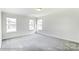Bright bedroom featuring plush carpets and multiple windows for natural light and street views at 1449 Ardmore Dr # 241, Sherrills Ford, NC 28673