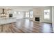 Open floorplan showcasing a fireplace, large windows, and hardwood floors connecting the living spaces at 1449 Ardmore Dr # 241, Sherrills Ford, NC 28673