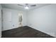Bedroom with a door to the bathroom and dark wood-look flooring at 1606 Sharon W Rd # 37, Charlotte, NC 28210