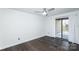 Bedroom with sliding door to balcony and dark wood-look flooring at 1606 Sharon W Rd # 37, Charlotte, NC 28210