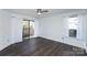 Bright bedroom featuring a ceiling fan, large windows and sliding glass door to private balcony at 1606 Sharon W Rd # 37, Charlotte, NC 28210