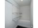Walk-in closet with wire shelving and a built-in bench for organized storage at 1606 Sharon W Rd # 37, Charlotte, NC 28210