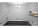 Inviting dining space with modern lighting and convenient access to kitchen through a pass-through at 1606 Sharon W Rd # 37, Charlotte, NC 28210