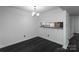 Cozy dining area with modern lighting and a convenient pass-through to the kitchen at 1606 Sharon W Rd # 37, Charlotte, NC 28210