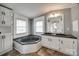 Bright bathroom features a soaking tub, double sink vanity with cabinet storage and modern fixtures at 164 Daves Rd, York, SC 29745