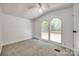 Neutral bedroom with vaulted ceiling, two windows and fan at 164 Daves Rd, York, SC 29745