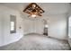 Bright main bedroom featuring neutral walls, carpeted floor, and a ceiling fan at 164 Daves Rd, York, SC 29745