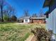 Spacious backyard with mature trees surrounding the property and a shed in the distance at 1730 Martin Rd, Kings Mountain, NC 28086