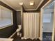 Bathroom featuring a shower with a curtain, toilet, and window for natural light at 1730 Martin Rd, Kings Mountain, NC 28086