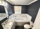 Modern bathroom with a soaking tub, subway tile surround, and vanity with a marble countertop at 1730 Martin Rd, Kings Mountain, NC 28086