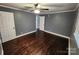 A bedroom features hardwood floors, neutral gray walls, white trim and white doors at 1730 Martin Rd, Kings Mountain, NC 28086