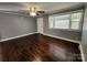 This bedroom features hardwood floors, natural light, gray walls, and white trim at 1730 Martin Rd, Kings Mountain, NC 28086
