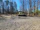 Driveway to a private area on the lot, with mature trees and a metal carport at 1730 Martin Rd, Kings Mountain, NC 28086