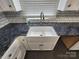 Close-up of a farmhouse-style kitchen sink with modern faucet and granite countertops at 1730 Martin Rd, Kings Mountain, NC 28086