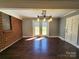 This is a living room with hardwood floors, gray walls, brick accents, and an updated light fixture at 1730 Martin Rd, Kings Mountain, NC 28086