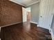An interior view of a living room with exposed brick walls and hardwood floors at 1730 Martin Rd, Kings Mountain, NC 28086