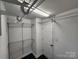 Functional walk-in closet with white walls, black floor and white door with a bright light at 1730 Martin Rd, Kings Mountain, NC 28086
