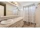 A well-lit bathroom features a double vanity, granite countertop, framed mirror, and shower-tub combination at 1852 Bon Rea Dr, Rock Hill, SC 29730