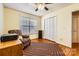 A well-lit bedroom features a closet, a window, and a colorful area rug on the wood floor at 1852 Bon Rea Dr, Rock Hill, SC 29730