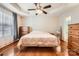 A bedroom with hardwood floors features a ceiling fan, neutral walls, a large window, and generous closet space at 1852 Bon Rea Dr, Rock Hill, SC 29730