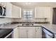 A well-lit kitchen features white cabinets, granite countertops, stainless steel appliances, and a window view at 1852 Bon Rea Dr, Rock Hill, SC 29730