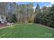 A level, green back yard with a lacrosse net sits behind this home at 19117 Davidson Concord Rd, Davidson, NC 28036