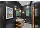 Elegant powder room with black shiplap walls, mosaic tile floor, and a stylish vanity at 19117 Davidson Concord Rd, Davidson, NC 28036