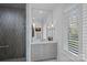 Bathroom vanity featuring a quartz countertop and marble shower at 19117 Davidson Concord Rd, Davidson, NC 28036