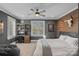 Bedroom with a wood accent wall, work station, ceiling fan, and natural light at 19117 Davidson Concord Rd, Davidson, NC 28036