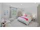 Charming bedroom with white wainscoting, a cozy loveseat, and bright natural light at 19117 Davidson Concord Rd, Davidson, NC 28036