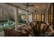Comfortable covered patio area with ceiling fans, wicker furniture, and a view of the pool at 19117 Davidson Concord Rd, Davidson, NC 28036