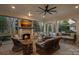 This covered patio features an outdoor fireplace, a large TV, and slate floors for the ultimate outdoor living experience at 19117 Davidson Concord Rd, Davidson, NC 28036