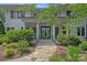Inviting front entrance with a stone walkway, manicured landscaping, and a stylish door at 19117 Davidson Concord Rd, Davidson, NC 28036