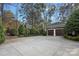 A three car garage has an adjacent basketball hoop at 19117 Davidson Concord Rd, Davidson, NC 28036