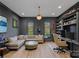 Home office with custom built-in shelving, a comfortable seating area, and plenty of natural light at 19117 Davidson Concord Rd, Davidson, NC 28036