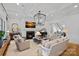 Cozy living room with fireplace, comfortable seating, and natural light at 19117 Davidson Concord Rd, Davidson, NC 28036